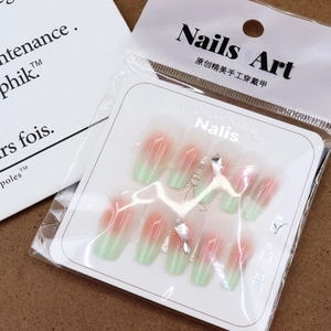 Pink and green gradient press-on nails with 3D rhinestones on branded display card