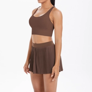 Detail of coffee brown two-piece sports set with open back bra and pleated tennis skirt