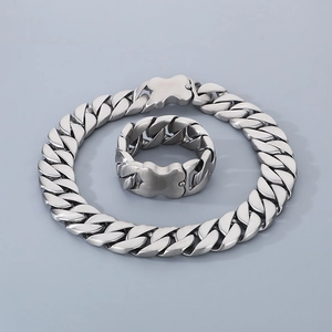 Polished silver Cuban link necklace and ring set with unique butterfly-shaped clasps