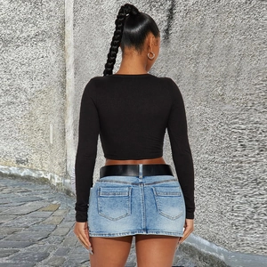 Rear view of slim fit long sleeve crop top with blue denim skirt and black belt