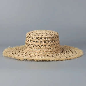 Detail of hollow-out weave raffia sun hat with vintage fringed edge and flat top style