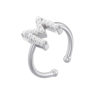 Detail shot of silver M-shaped ear cuff with inlaid white pearls on white background