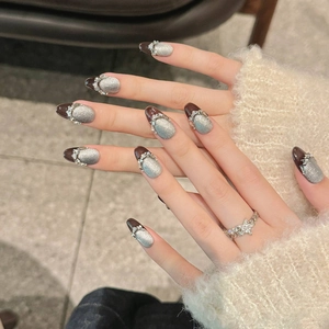 Handmade black cat-eye press-on nails with silver glitter and rhinestone accents