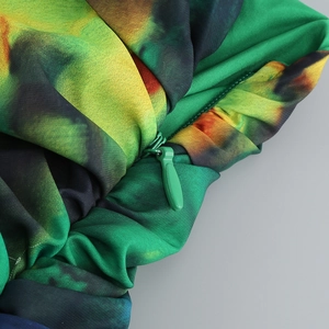 Detail of high-quality invisible zipper on a green and yellow abstract print dress