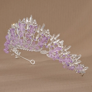 Detail of silver alloy tiara featuring purple crystals and intricate leaf patterns