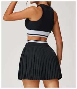Close-up of seamless racerback sports top and pleated skirt with striped elastic band