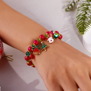 Christmas charm bracelet with Santa, reindeer, and bells shown on a wrist