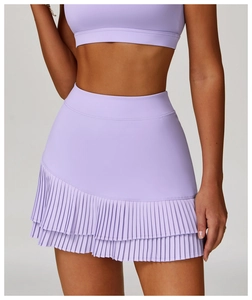Detail of high-waisted pleated tennis skirt in lavender with moisture-wicking fabric