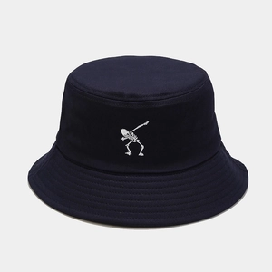 Detailed close-up of white skeleton embroidery on a navy blue cotton bucket hat