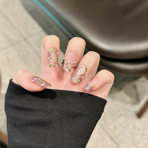 Handmade press-on nails with pink 3D flowers, pearls, and cat-eye finish on long coffin shape