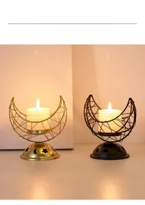 Detail of crescent moon metal incense burners in black and gold with star hollowed base