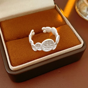 Detailed macro view of an oval textured silver ring placed inside a velvet jewelry box