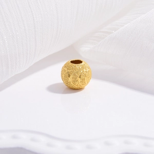 Macro detail of golden frosted S925 silver spacer bead with elegant carved star pattern