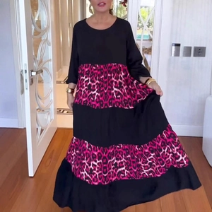 Detail of elegant leopard print patchwork long sleeve dress with tiered skirt