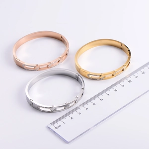 Detailed comparison of gold and silver Roman numeral bracelets with a size measurement ruler