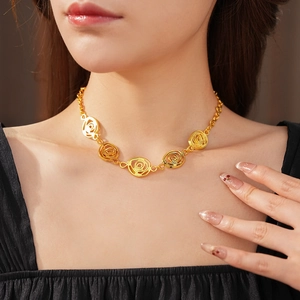 Detail shot of vintage hollow rose pendant necklace in gold finish worn by a model