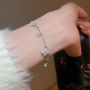 Close-up of elegant silver bracelet with pearl flower and shimmering zircon crystals
