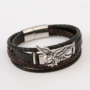 Close-up of eagle charm and magnetic clasp on braided leather bracelet for men