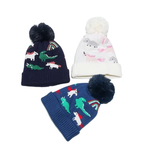 Winter knit hats for kids with dinosaur and unicorn patterns and fluffy pompoms