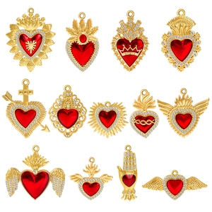 Collection of gold-plated sacred heart pendants with red rubies and sparkling rhinestones
