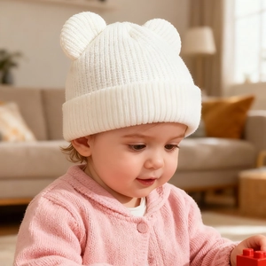 Close-up of white knit baby hat with bear ears and soft ribbed texture for infants