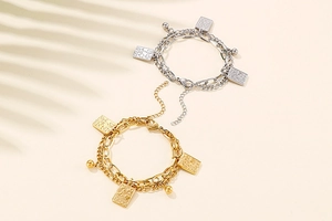 Detail of double-layer steel chains with gold and silver rectangular playing card pendants