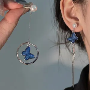 Asymmetrical shell fringe hoop earrings with blue butterfly charms and white pearls