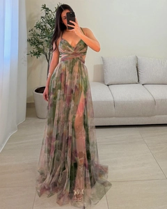 Close-up of floral mesh dress with side slit and large hemline detail in indoor setting