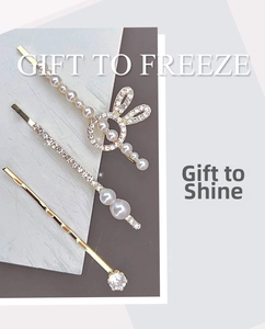 Detail view of gold-plated hair pins set with elegant pearls and sparkling rhinestones