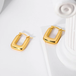 Detailed view of square 18K gold stainless steel earrings on a decorative pedestal