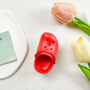 Detailed view of mini red slipper phone stand with breathable holes and rotating strap