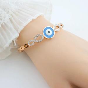Detailed close-up of rose gold infinity evil eye bracelet with white zircon inlay