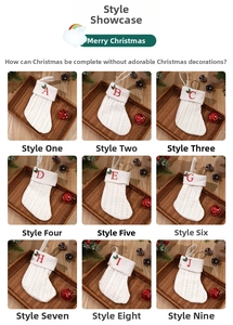 Collection of white knitted Christmas stockings with red letter embroidery on wood