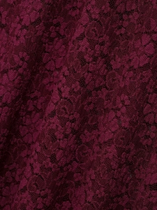 Close-up of elegant burgundy lace fabric with intricate floral crochet patterns