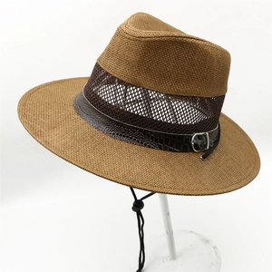 Detail of brown straw fedora with breathable mesh panels and crocodile pattern leather strap