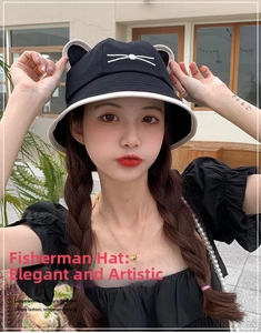 Detail of cute cat ear design and white whiskers embroidery on a black cotton bucket hat