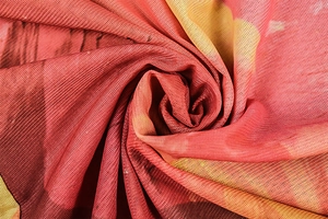 Detail of red and yellow gradient mesh fabric with a lightweight and sheer texture