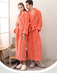 Close-up of thick coral orange waffle texture fabric on long-sleeved couple robes