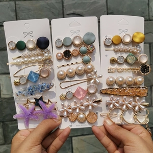 Detailed set of colorful candy-colored hair pins with pearls and shells on display cards
