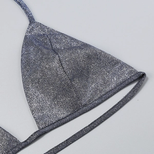 Close-up of silver blue sequined bikini top with thin straps and metallic glitter texture