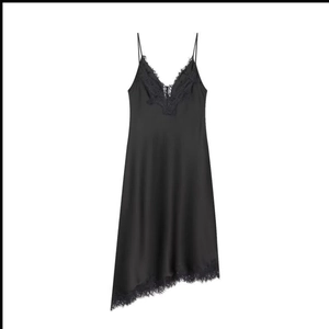 Detailed close-up of delicate black lace trim and silk texture on the dress hemline