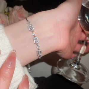 Detailed view of silver zircon bracelet with adjustable slide clasp on a model's wrist