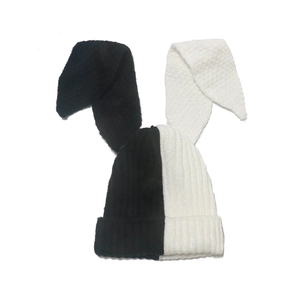 Close-up of black and white contrast knit texture on a long rabbit ear winter beanie