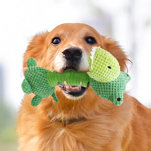 Green crocheted animal squeaky toy for dogs being held in a Golden Retriever mouth