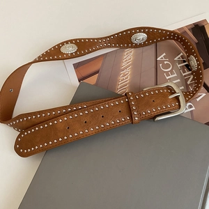 Vintage brown leather belt with silver studs and embossed metal pieces in western style