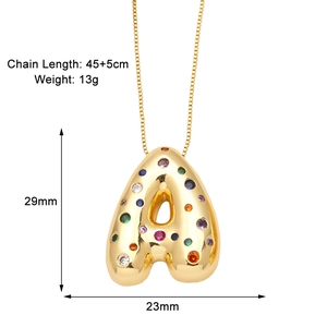 Detail view of 3D gold letter A pendant with colorful zircon stones and chain specs
