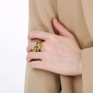 Snake-shaped gold stainless steel ring with star pattern stones worn by a model