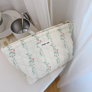 Macro detail of quilted floral makeup bag with simple wish label and soft cotton texture