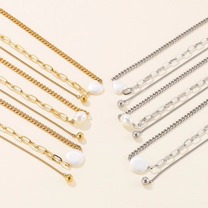 Layered gold and silver titanium steel necklaces with heart pendants and pearls