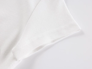 Close-up of high-quality stitching and cotton fabric texture on white polo shirt cuff